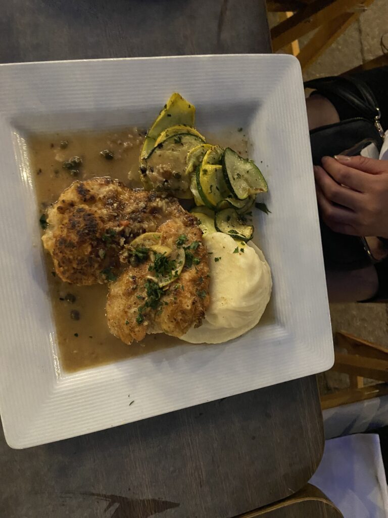 Breaded Chicken breasts with mashed potatoes, zucchini squash with caper sauce.