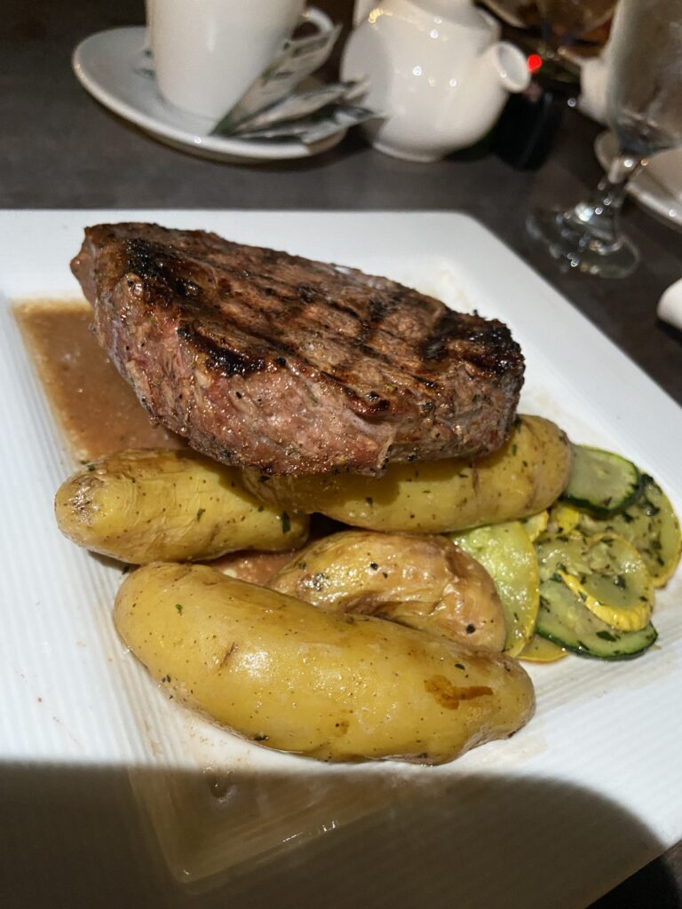 Steak with potatoes and zucchini.