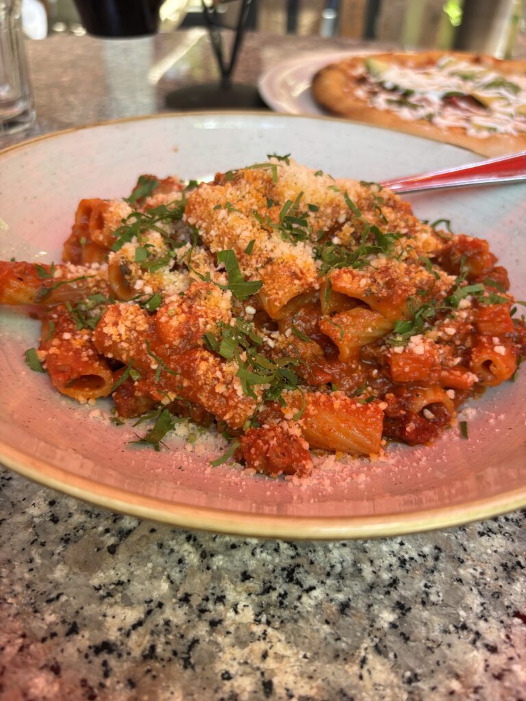 Rigatoni Bolognese. Rigatoni pasta with a pork and beef ragu, topped with pecorino cheese and parsley