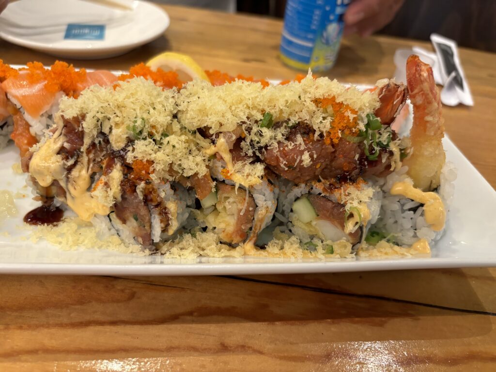 Shrimp tempera, spicy tuna, cucumber roll topped with spicy tuna, tempera flakes, tobiko, scallions, eel sauce, and spicy mayo.